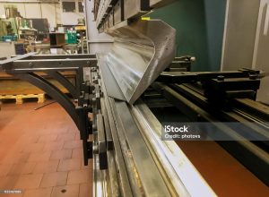 Sheet metal bending in factory machine in metal fabrication