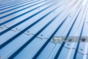 blue corrugated metal roof with rivets, industrial background